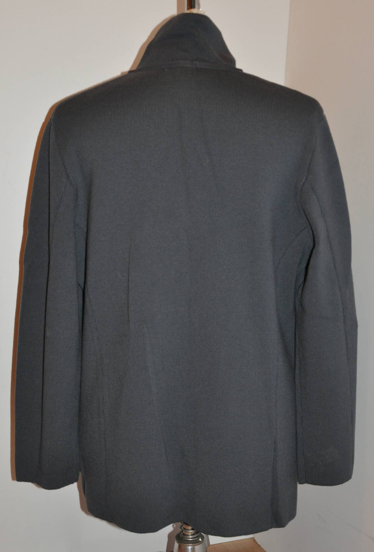 Gianfranco Ferre wonderfully tailored men's gray medium-weight wool-blend sweater-jacket is detailed with two(2) front patch pockets. The shoulders are slightly draped with the shoulders measuring 19 1/2