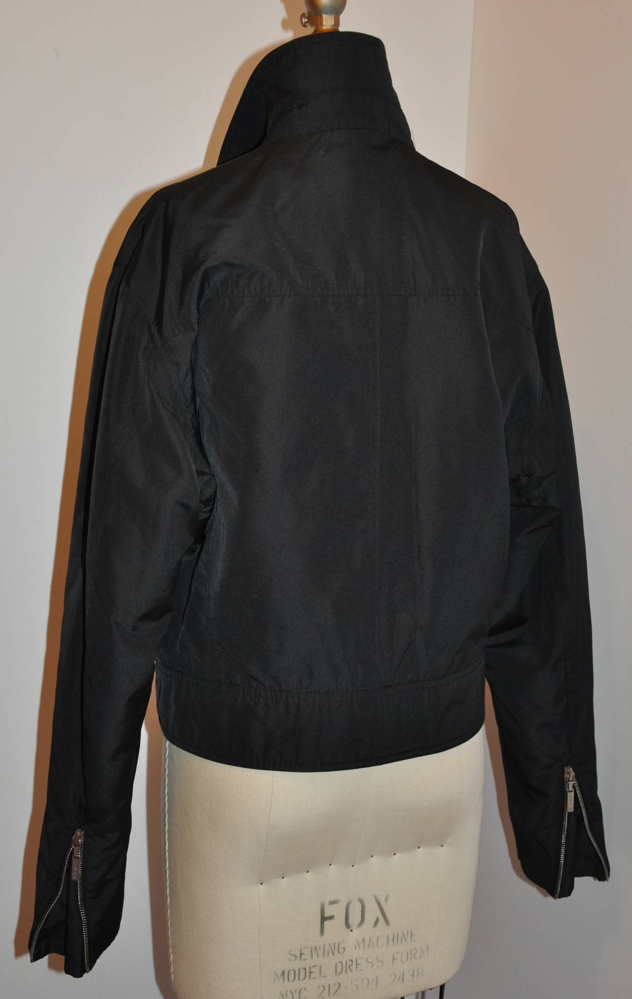 Yves Saint Laurent men's zipper jacket is fully lined accented with two (2) interior breast pockets. The exterior has two pockets accented with a flap. The collar measures 2