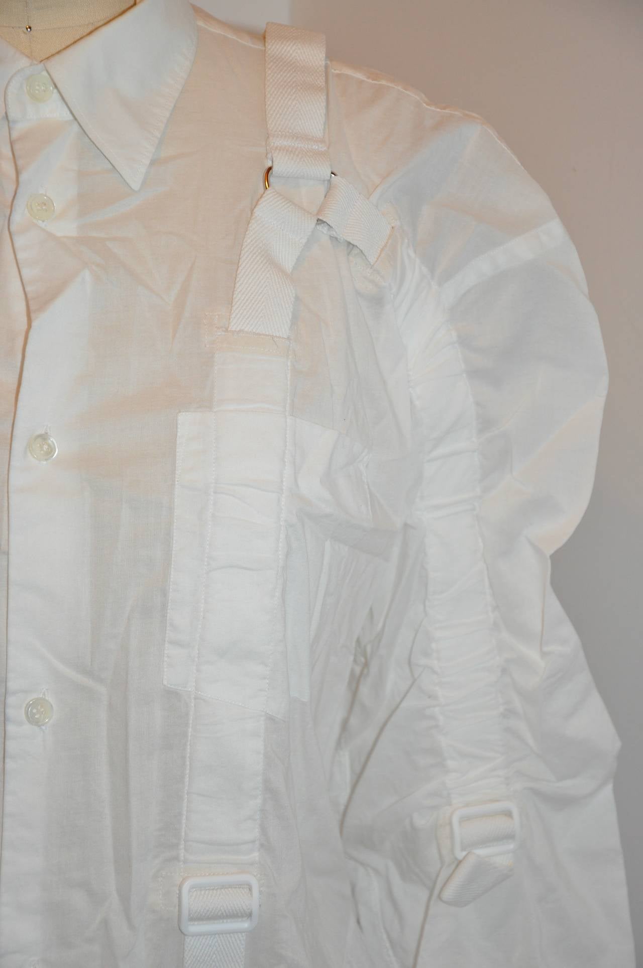 This wonderfully wicked Junya Watanabe Comme des Garcons white deconstructed button shirt is wildly detailed with adjustable woven cotton drawstrings throughout the front, back and also on the sleeves. The front has six buttons along with an extra