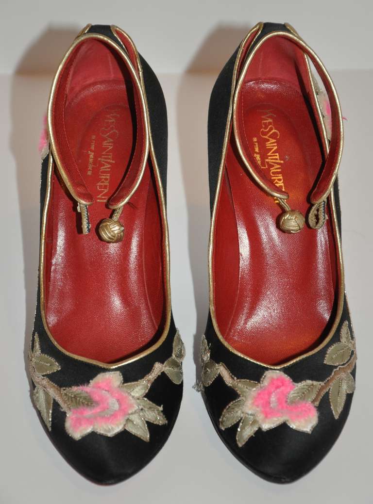 This wonderfully wicked Yves Saint Laurent blood-red patent-leather wedge shoe has black silk-satin upper accented with detailed hand-embroidered combination of floral and leaves in green and beige silk, and finished with  etching in metallic gold