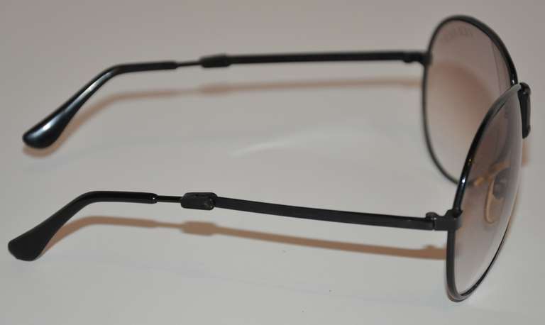 Ferarri black lucite frame folding sunglasses measures 2 1/4