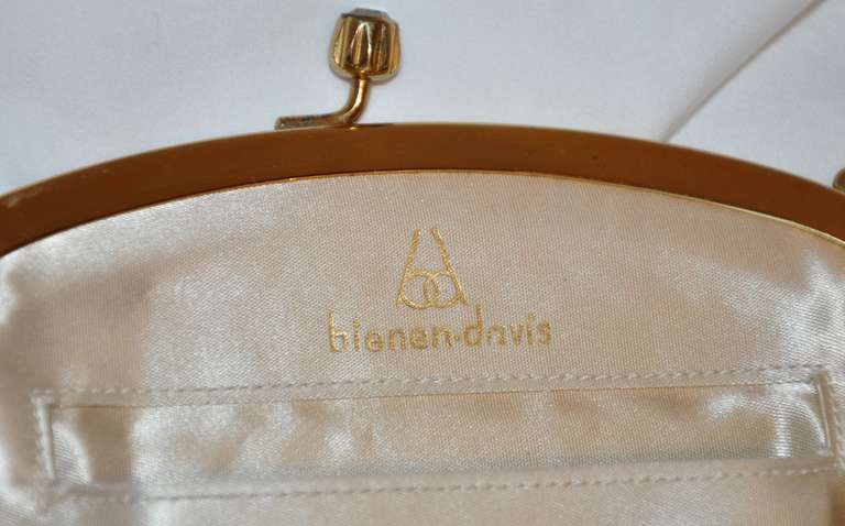 Bienen - davis floral embroidery & velveteen handbag has a gold hardware frame along with a gold hardware chain handle. The fully lined interior of cream silk includes a wrapped-in-tissue mirror.
   Burgundy velveteen with floral embroidery on a