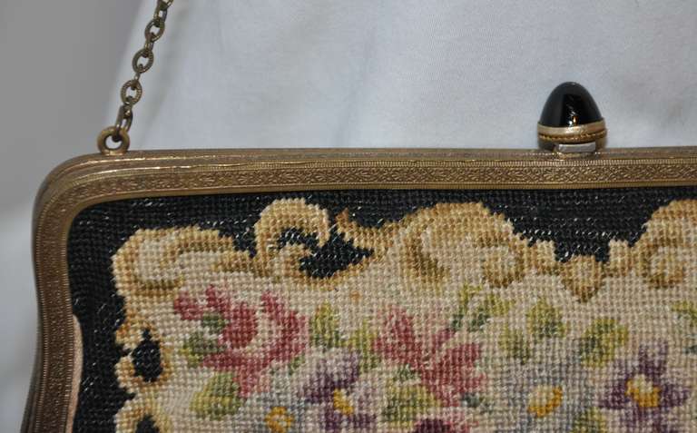 Multi-colored floral hand-done Tapestry in colors of burgundy, black, rose, beige, tan, beige, warm coco, and pale greens makes for a rich combination of this handbag. The gold hardware frame is accented with black glass stones on top.
   The
