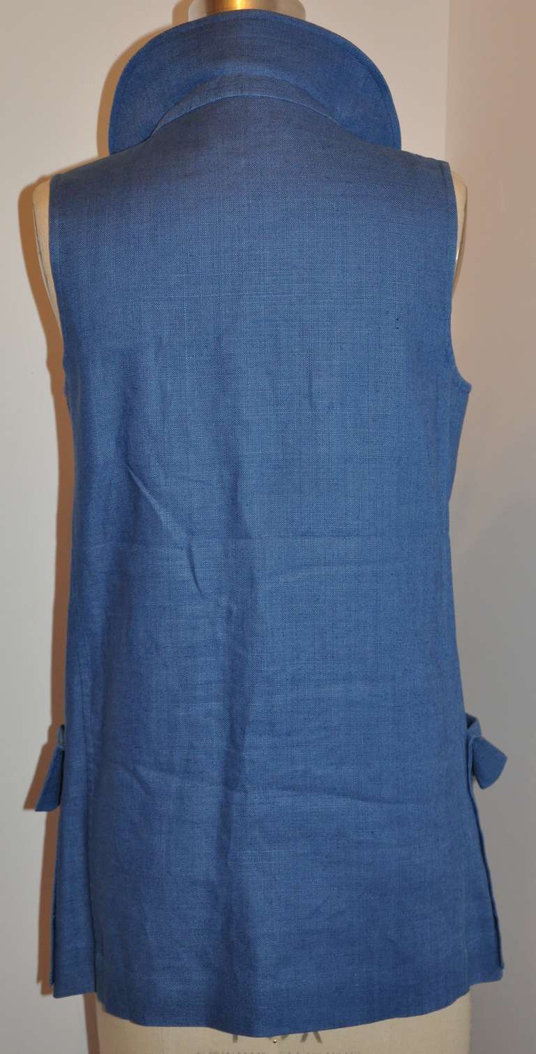 This wonderfully classic Yves Saint Laurent sleeveless top is double-breasted and accented with mother-of-Pearl buttons along with a extra button located in the interior. This top has two front patch pockets with flap. 100% linen in navy, there are