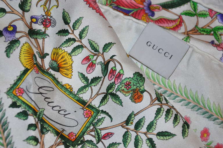 Gucci's wonderfully multi-colors silk floral print scarf is one of their signature classics. 
   Silk scarf measures 34 1/2