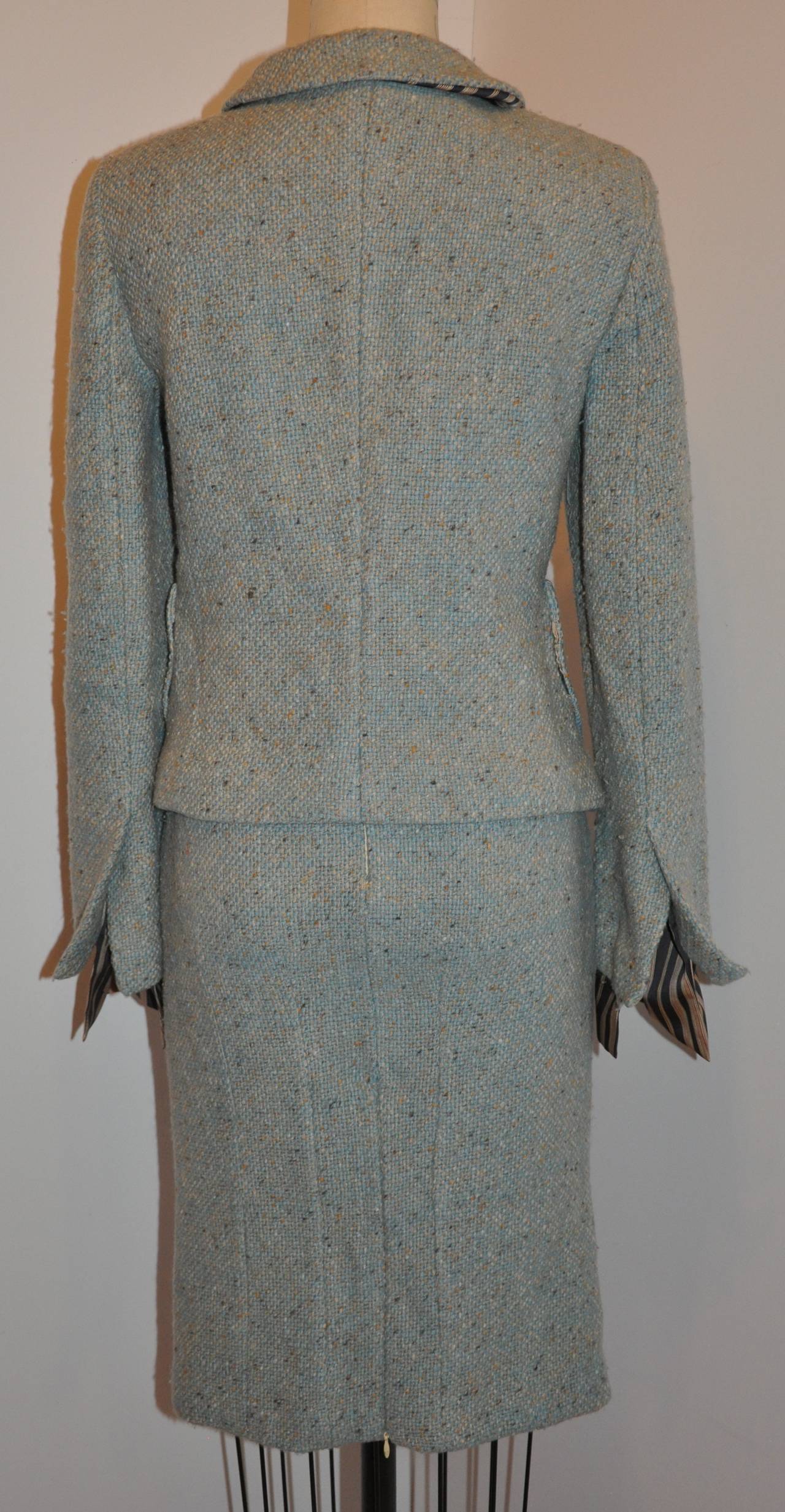 Gianfranco Ferre wonderful combination of tweed and lined with striped silk makes for a wonderful ensemble, finished with a single rhinestone embellished hardware button in front. The jacket has two patch pockets with all interior stems covered with