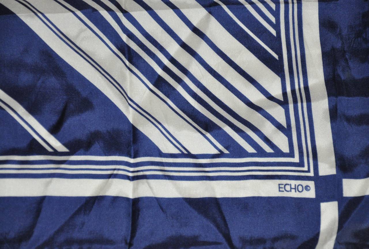Echo navy & cream abstract silk scarf is finished with hand-rolled edges and measures 26" x 26".