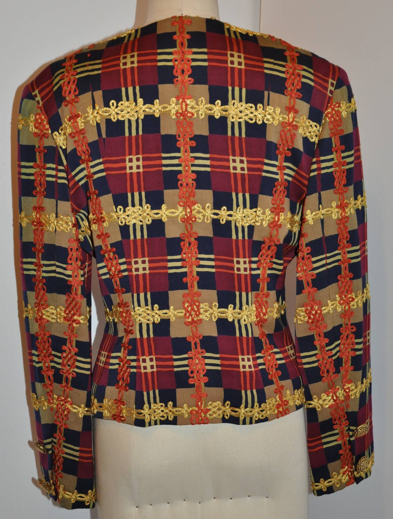 Christian LaCroix multi-color multi-plaid jacket is accented with wonderful embroidery in brunt tangerine as well as gold throughout. The buttons are gild gold hardware, four(4) in front and two(2) on each cuffs. 
     The shoulder measures 17