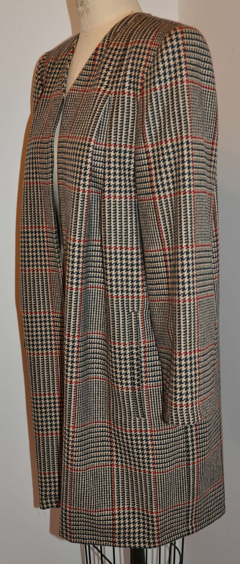 This classically Valentino plaid open coat is fully lined. The multi-colors of the plaid are in black, red, camel and cream. Padded shoulders of this lightweight car coat hangs just beautifully on the wearer.
   The front measures 30