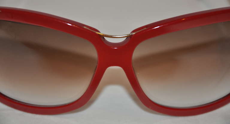 This wonderful Yves Saint Laurent in burgundy sunglasses is accented with his signature 