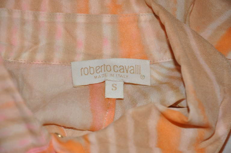 Roberto Cavalli multi-colors of coral, pink, cream, tan and beige are accented with six small gold hardware buttons. The sleeve's cuff are highlughted with ties which measures 19