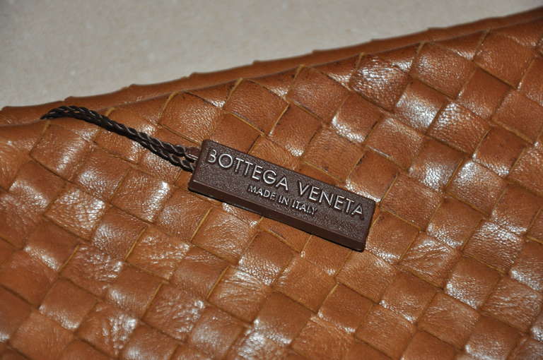 Bottega Veneta's wonderful signature woven lambskin leather Hobo shoulder bag is fully lined with a large zippered compartment.
   The straps stands at 12