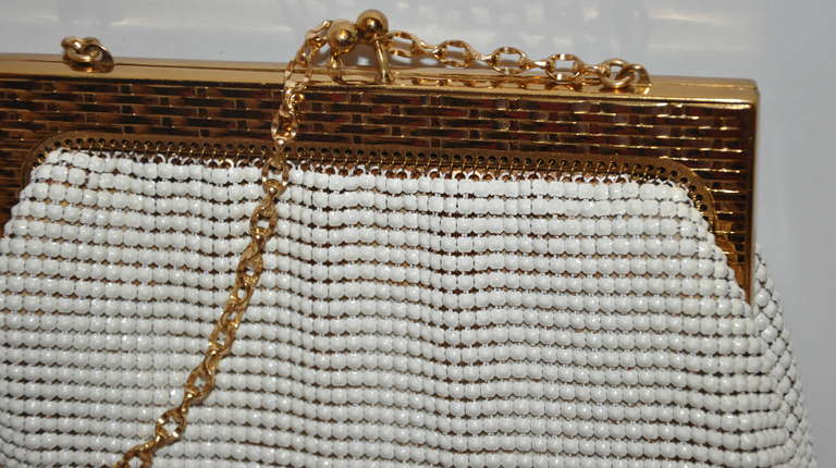 This wonderfully petite Whiting & Davis white & gold hardware mesh handbag is accented with a textured 