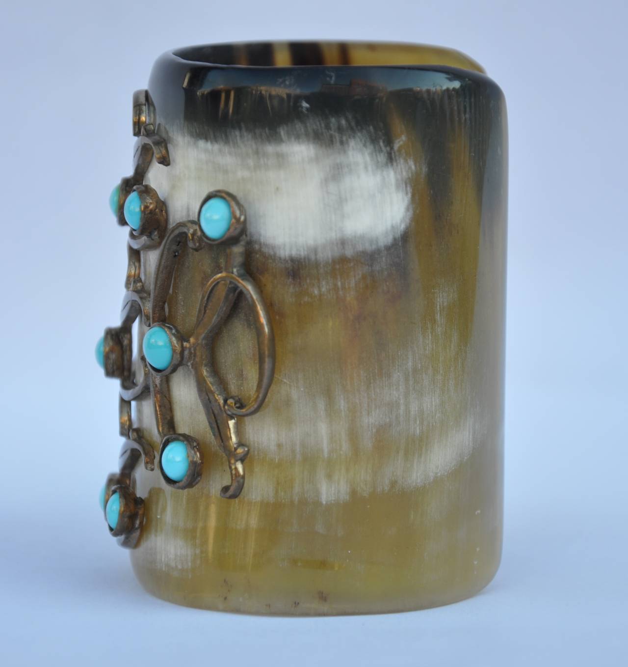          This rare, important and wonderfully detailed and signed Oscar de la Renta horn cuff is accented with detailed tortoise stones surrounded with swirls of brass. The total height measures 3". The circumference ranges from 2 1/8" to