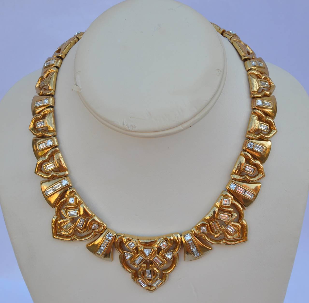 Yves Saint Laurent wonderfully detailed gilded gold vermeil finish thick necklace with matching earrings are accented with multi-size rhinestones. Both the necklace and matching earrings are signed on the backside. Besides the necklace being signed