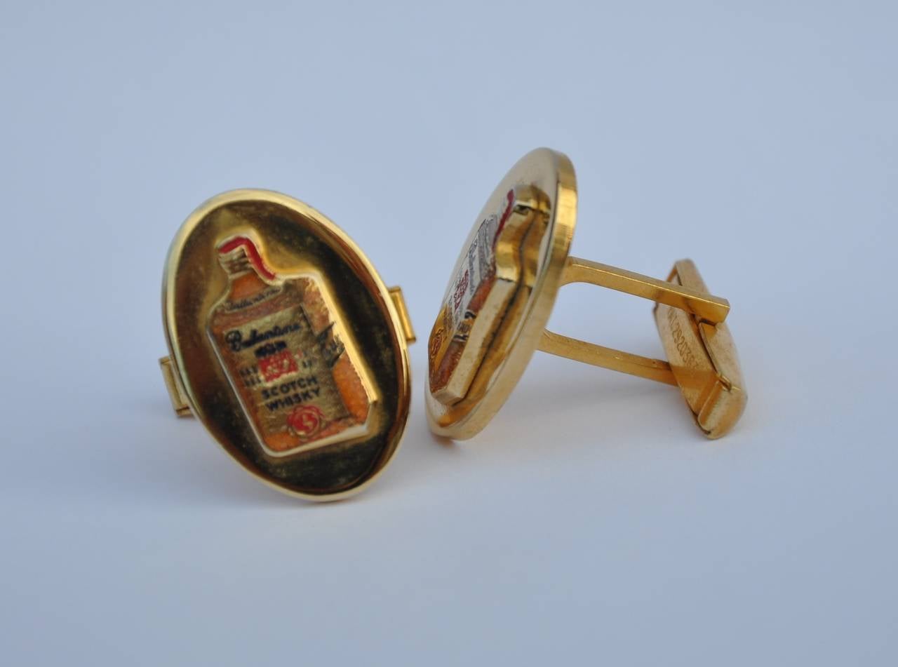        These whimsical cuff links from Ballantine's Scotch in gold tone metal measures 7/8" in length, 5/8" in width and 2/16" in depth. Wonderfully detailed with their signature scotch label.
