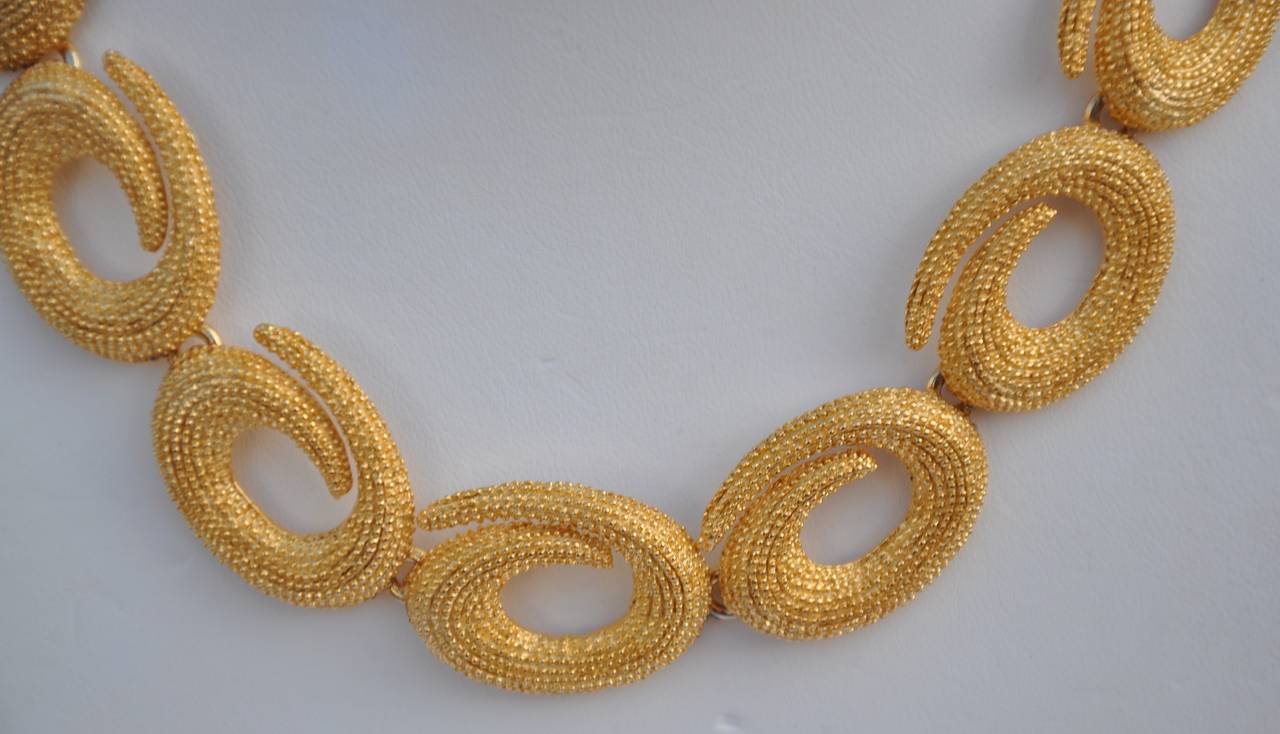 Vintage gild gold hardware necklace measures 16 1/4" in length. Width measures 1" with 2/8" in height when laid.