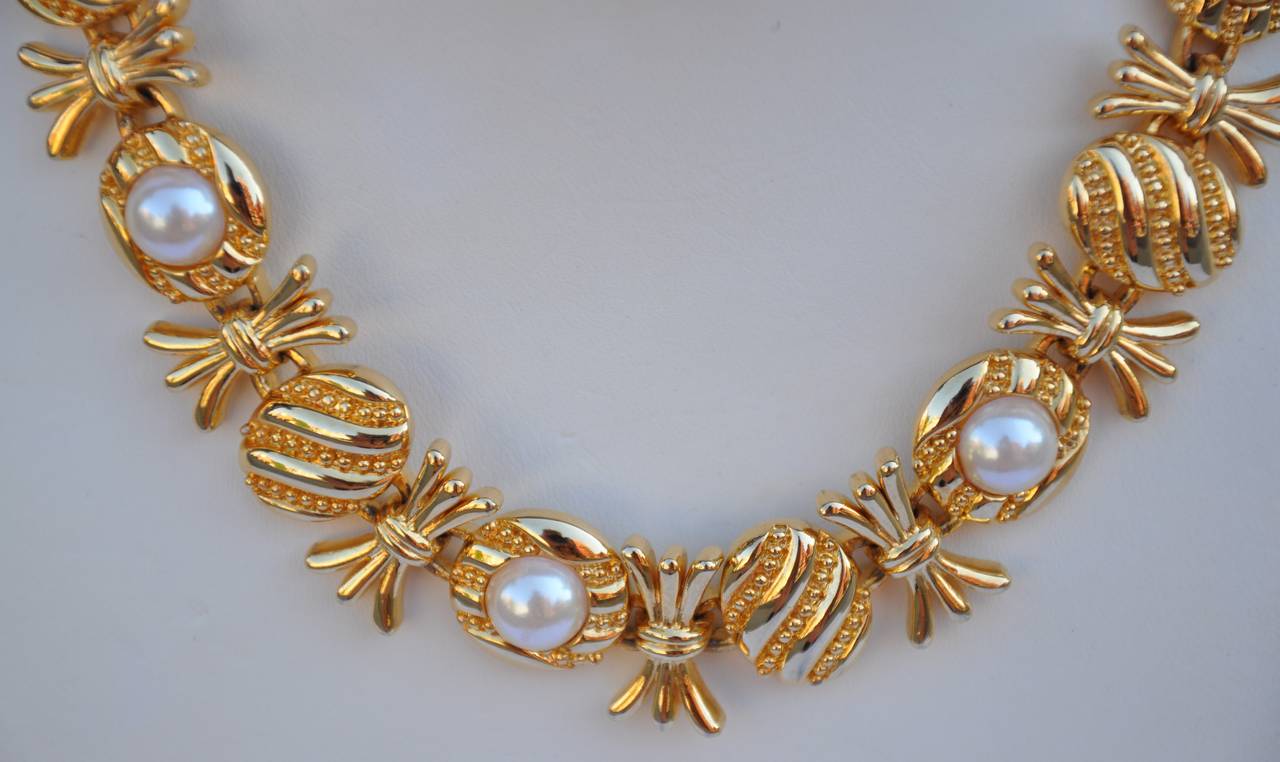        This thick vermeil finish gold hardware floral necklace is accented with pearls. Highly polished because of the vermeil finish, measures 14" in length, with three extra links at the end to lengthen if desire. The width measures