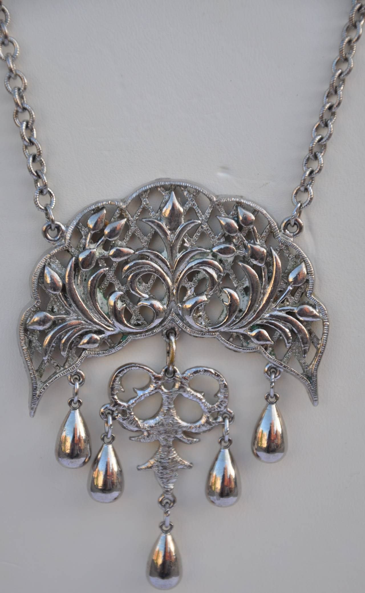 Large gilded silver hardware pendant has movable sections. The pendant measures 3" in height, 2 3/8" in length and 2/8" in depth. The necklace measures 21" in total length, with 3" links at the end to lengthen if desired.