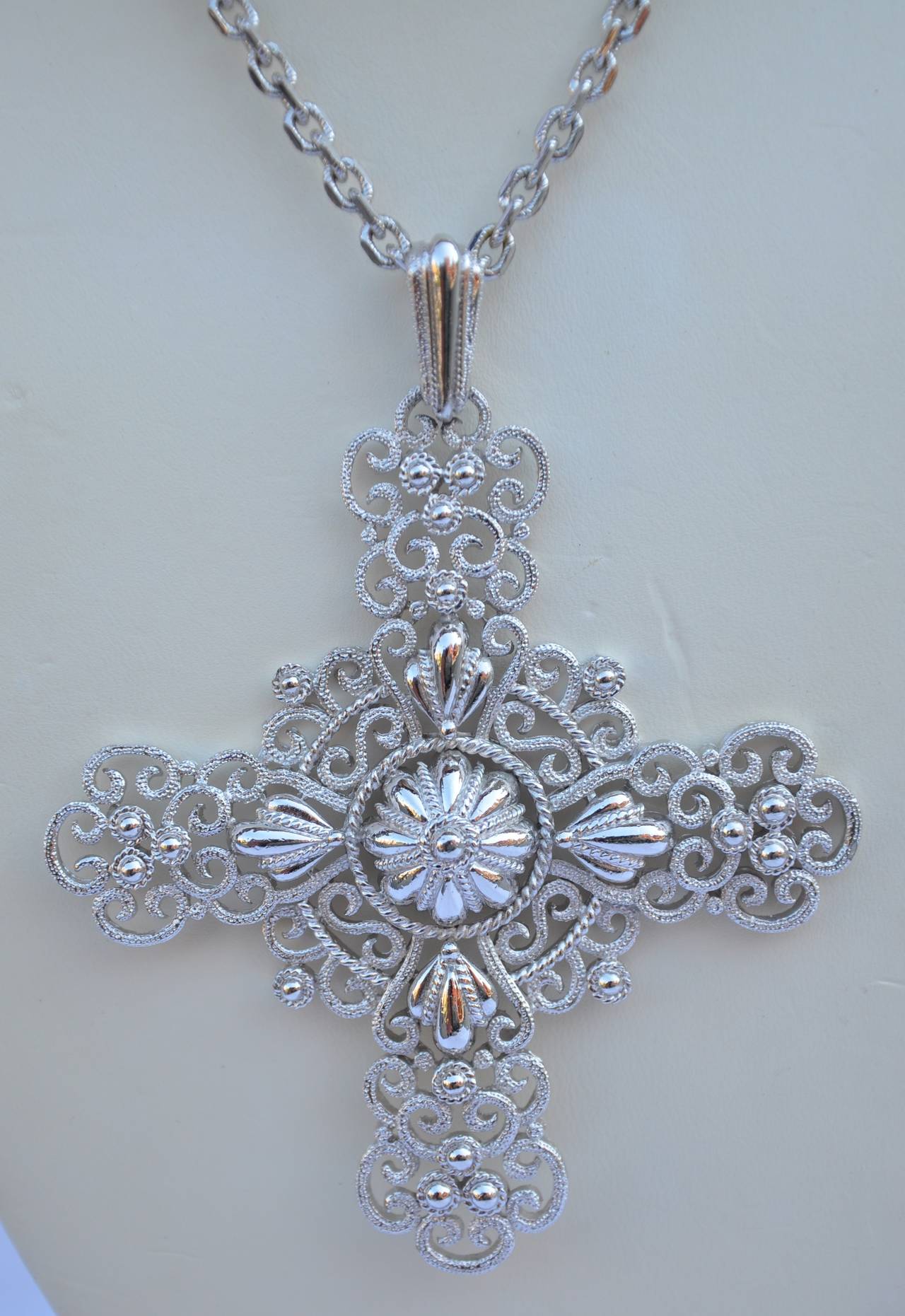 Trifari wonderfully detailed gild silver with filigree on both Pendant and necklace. The pendant itself measures 4 1/2" in length, width is 3 1/2", and depth is 3/8". The necklace measures 28" in length. Pendant is signed on the