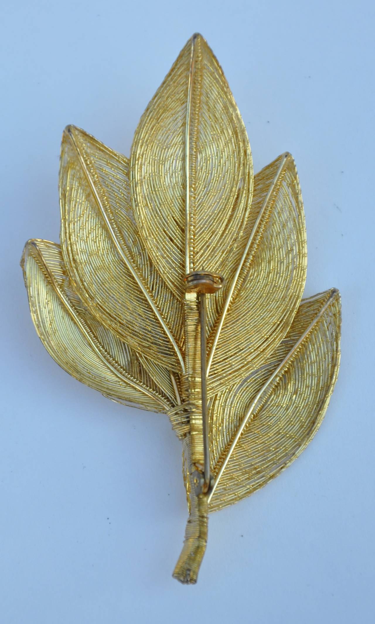 Large gilded gold filigree "Leaves" brooch are movable if desire. The length measures 3", height is 2", depth is 5/8".