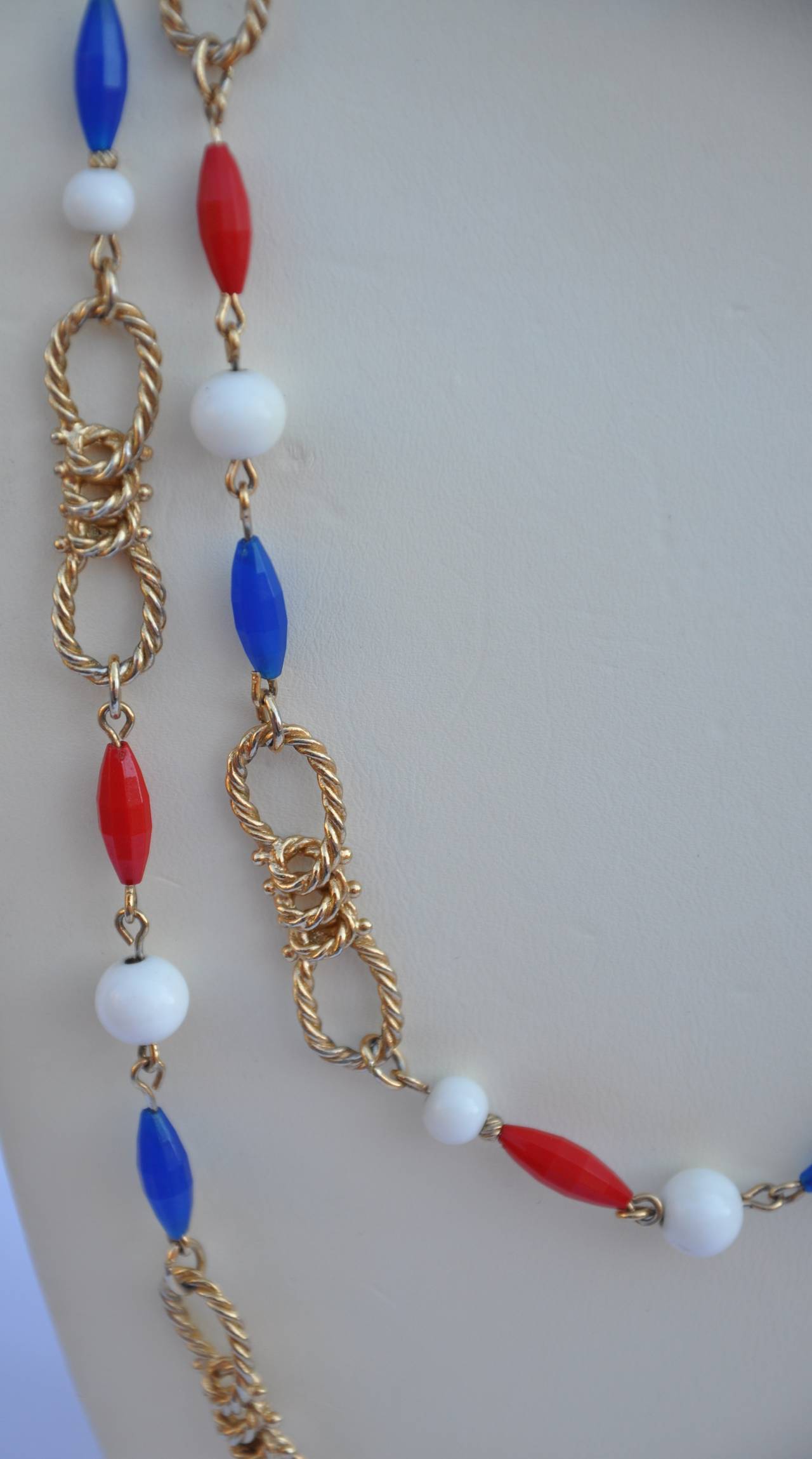 Trifari wonderful gilded gold vermeil hardware is paired with multi-colors of red, white and blue beads. The necklace measures 46" in total length. Necklace is signed.