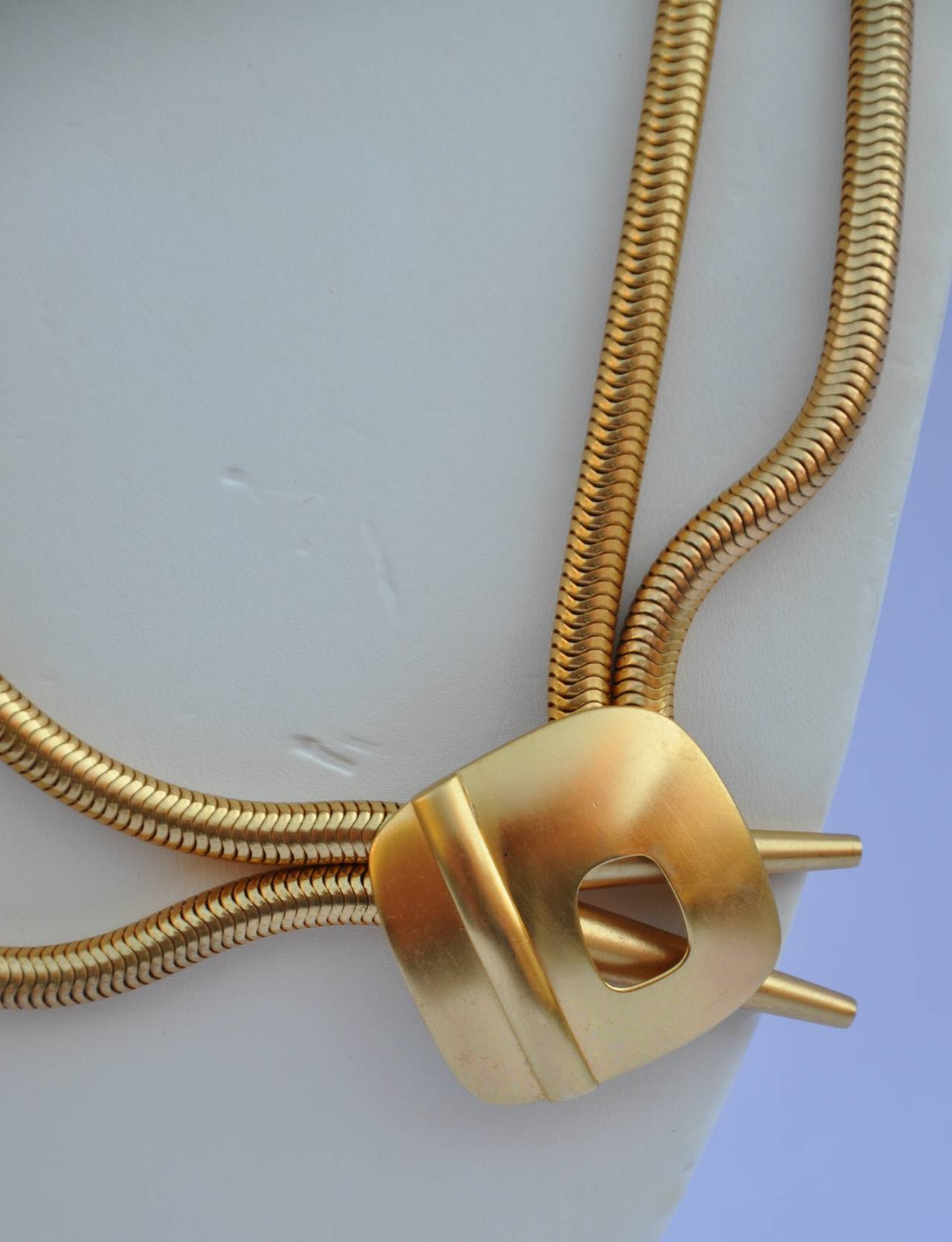Bold gilded gold vermeil finish snake chain necklace measures 181/2" along the inner side and 24" along the outer side. The pendant itself measures 1 1/2" x 1 1/2".