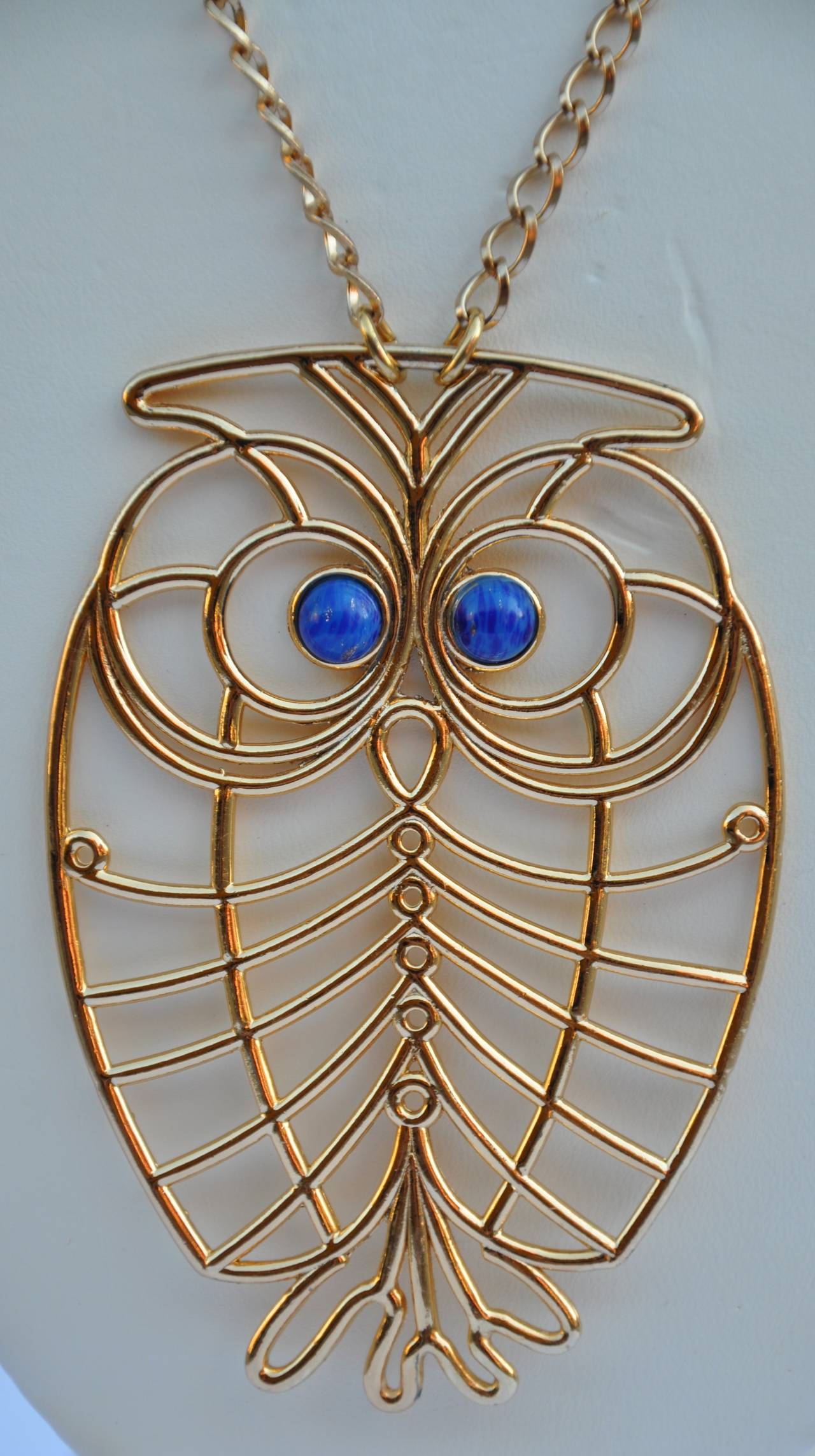       This wonderfully whimsical Napier "Owl" pendant and necklace is finished in gild gold hardware. The pendant is signed along the backside. The necklace measures 30 1/2" in total length. The pendant measures 3 1/2" in