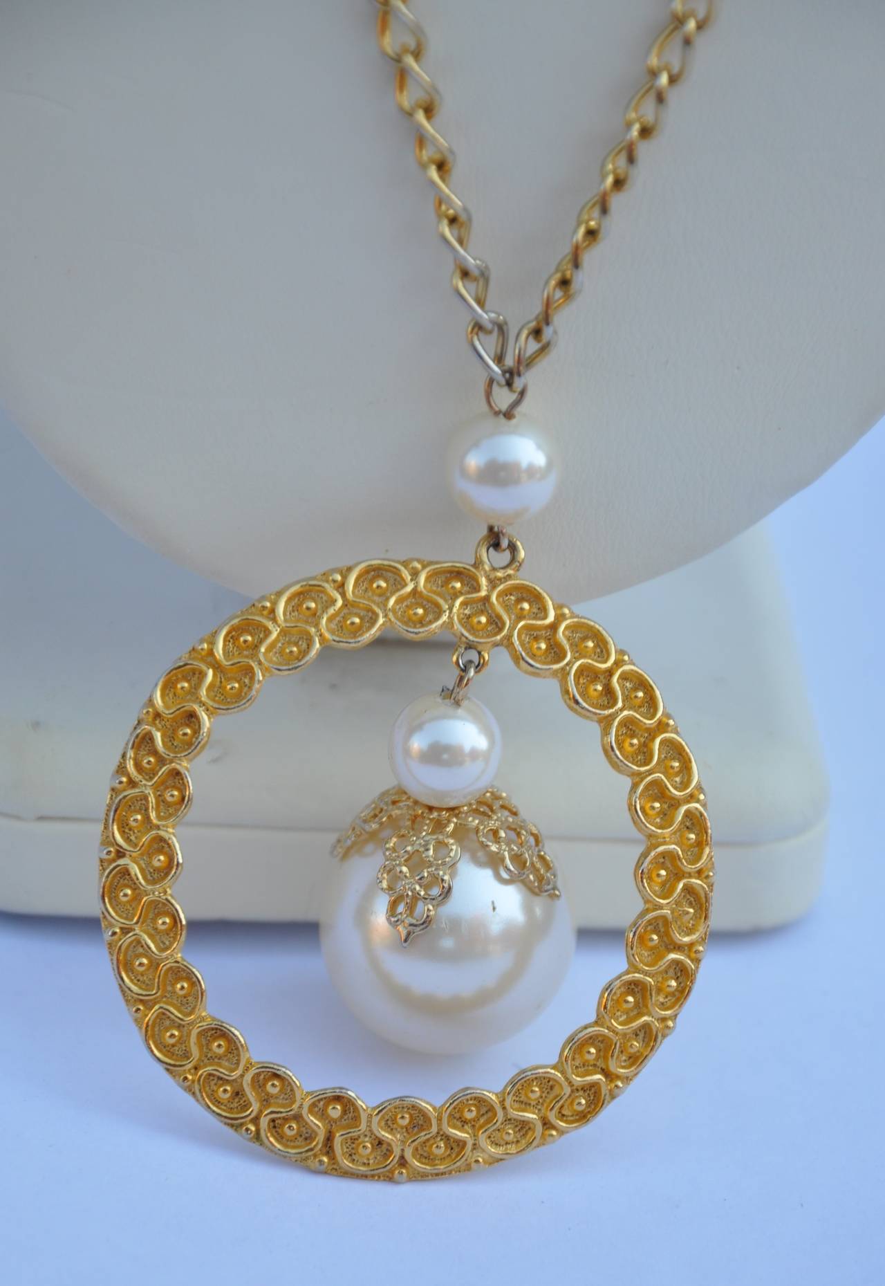 This wonderfully detailed circular gilded gold vermeil with filigree finish is centered with a large "Pearl" as well as the necklace which also has accents of "pearls" along the chain. The pendant measures 2 1/8" in