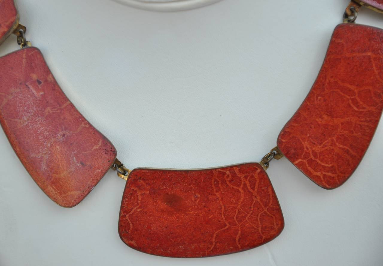 Chunky brass frame choker is accented with amber-shade resin ranging from 2 3/8" x 1 3/8" to 6/8" x 2 1/8" in size. The circumference of the choker measures 17" around the neck, depth measures 1/8" in thickness.