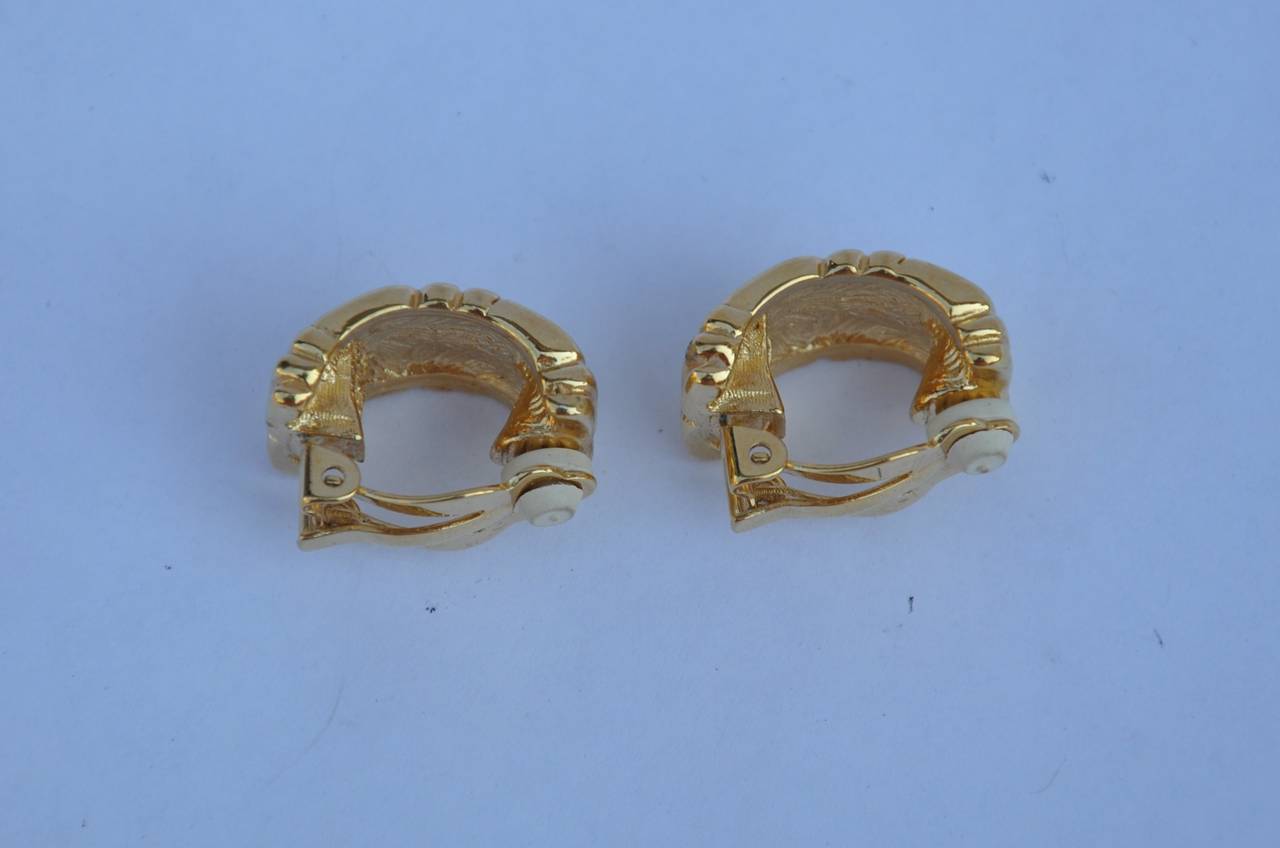 Givenchy signature logo in gilded gold vermeil finish ear clips measures 1" in height, 6/8" in length and 2/8" in depth. The backside are signed.