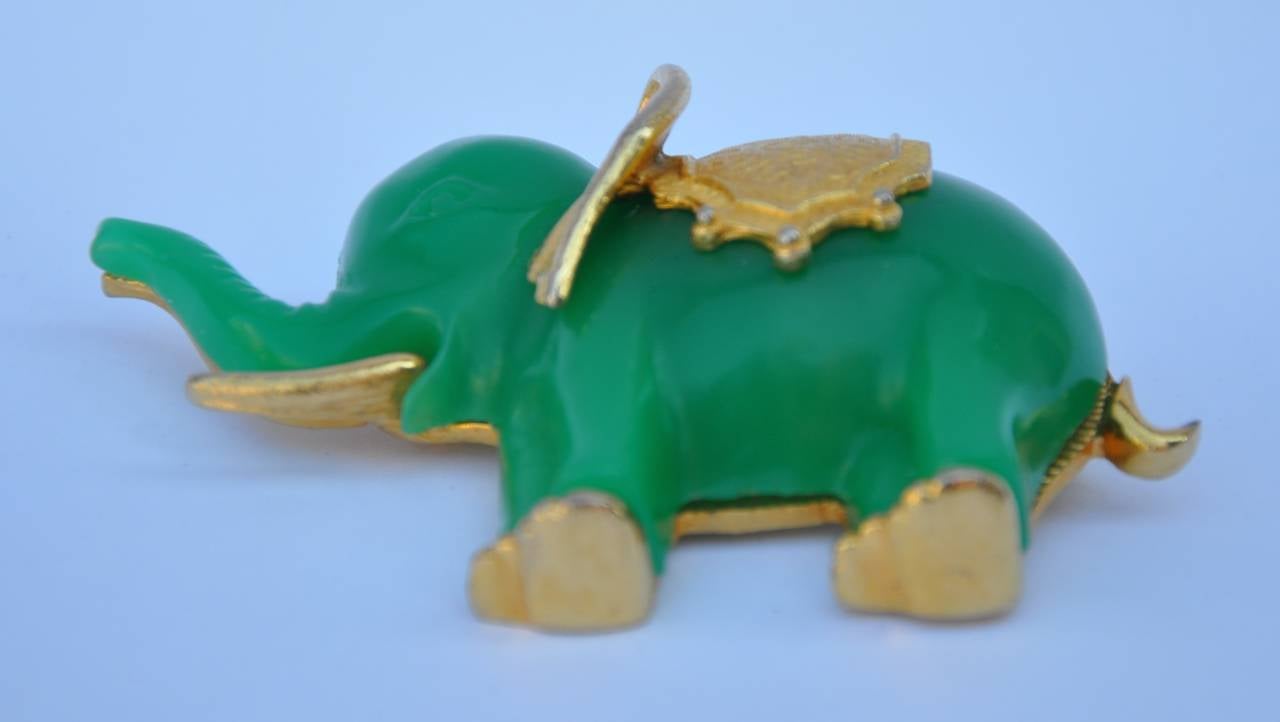 This wonderfully whimsical huge Jadeite resin with gold tone hardware "Elephant" doubles with your choice of either a brooch or as a pendant. This huge elephant piece measures 3 1/4" in length, height is 2", and depth is 1".