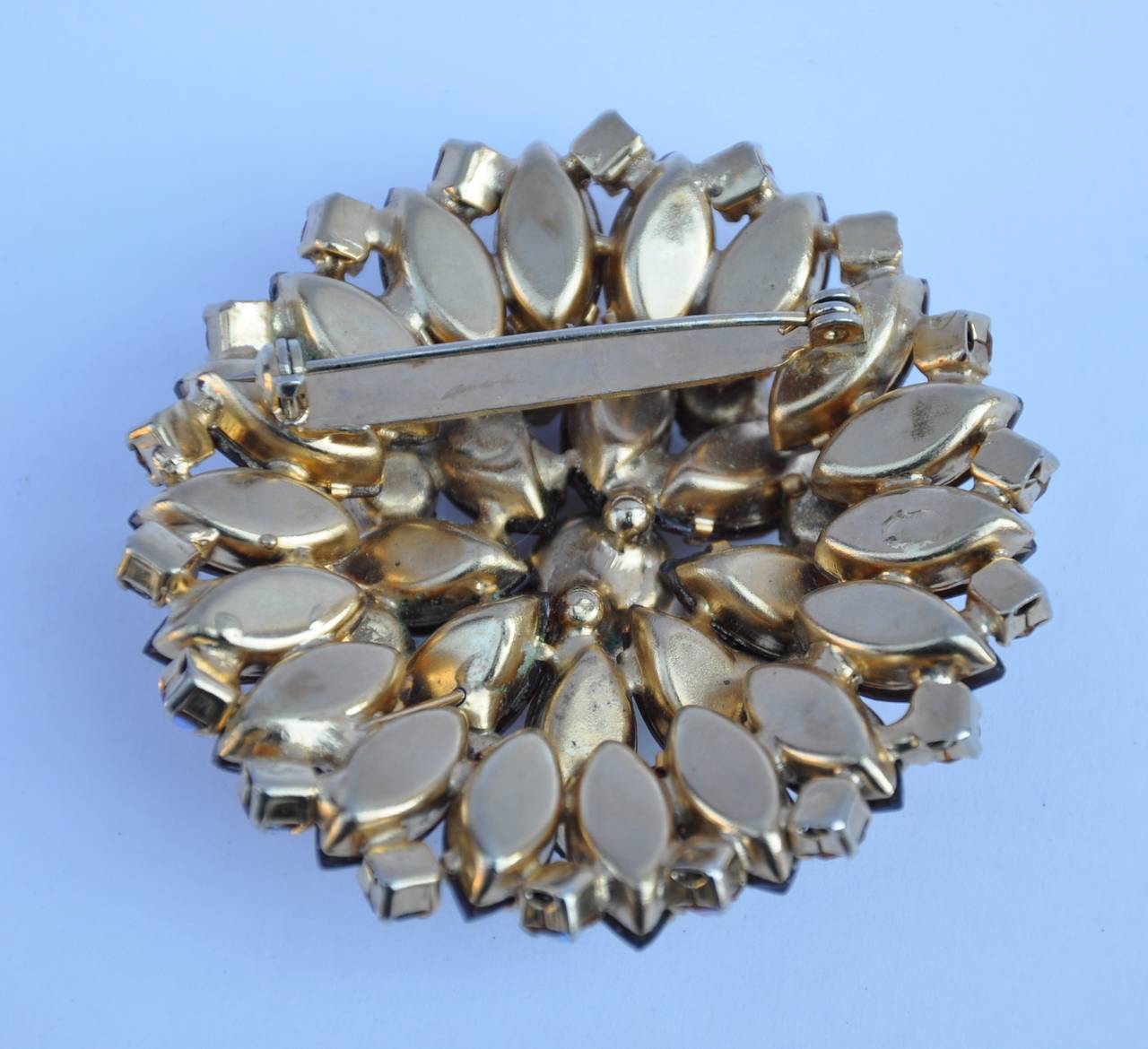 This large multi-color multi-facet rhinestone brooch measures 2 1/4" in total circumference and 5/8" in depth.