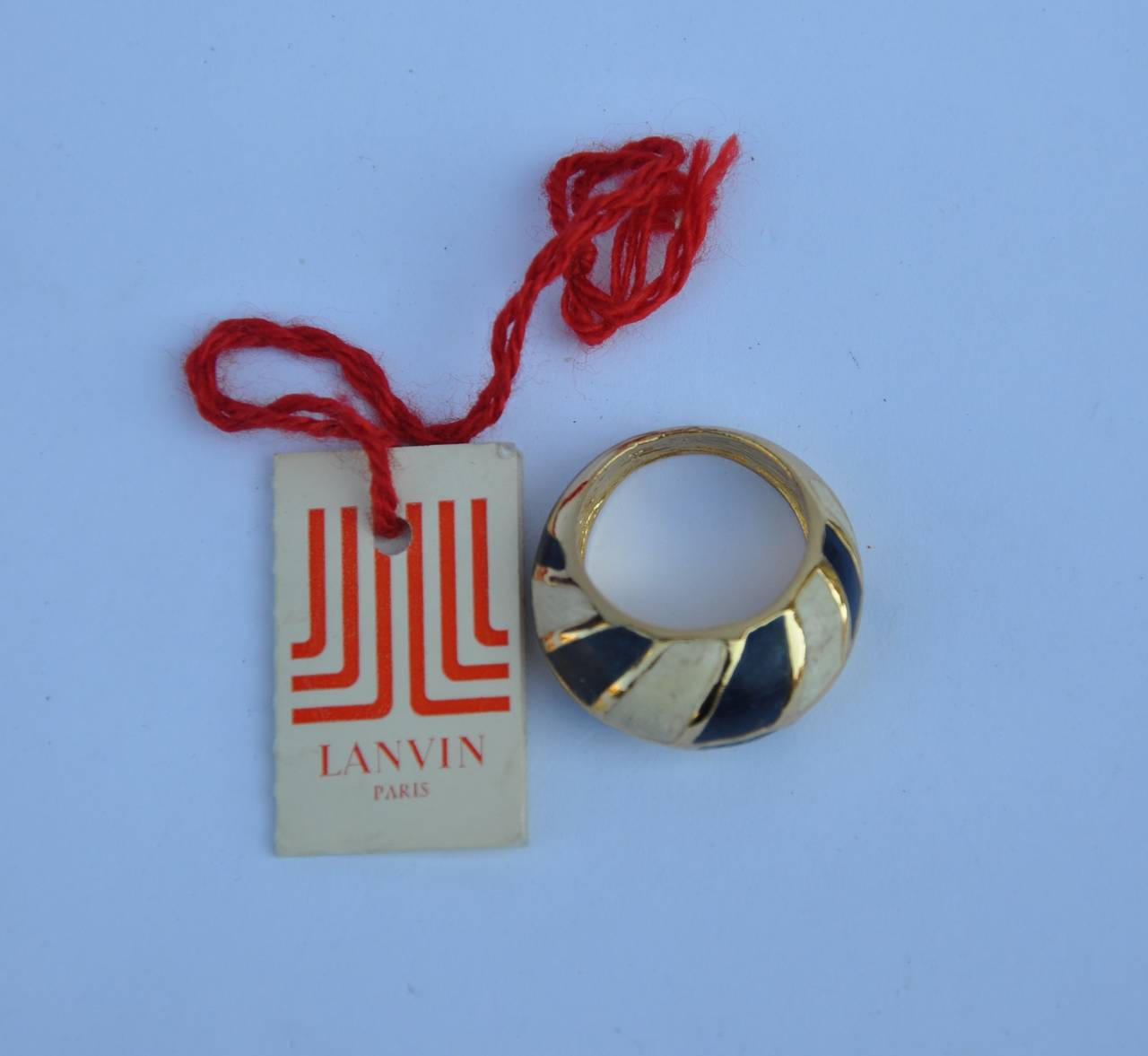 Lanvin's wonderful combination of navy with cream enamel finish over gold vermeil finish ring is size 7 1/2". Original tags attached. The depth measures 5/16.