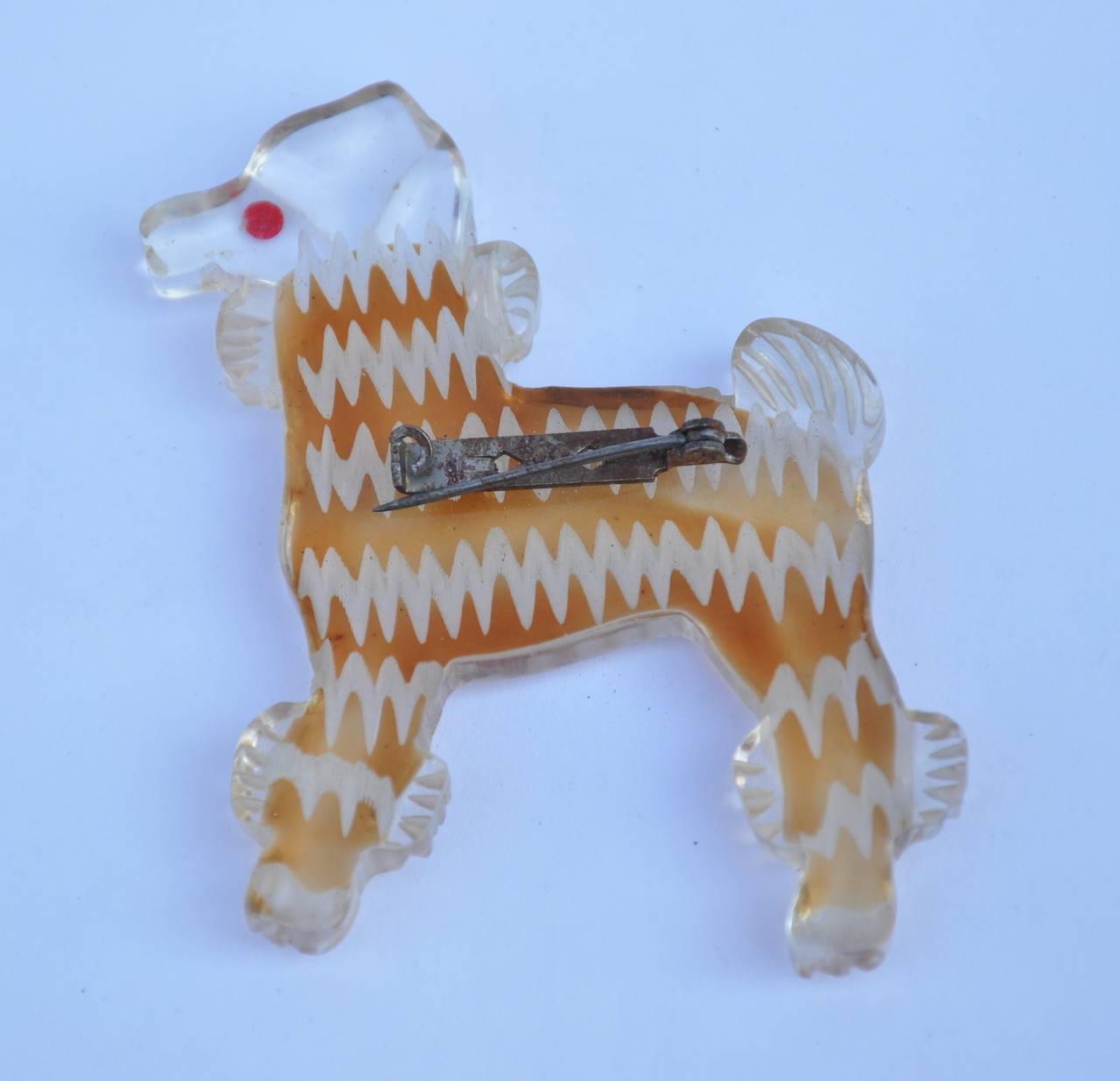 Large lucite "Poodle" brooch measures 2 6/8" in height, 2 3/8" in length and 2/8" in depth