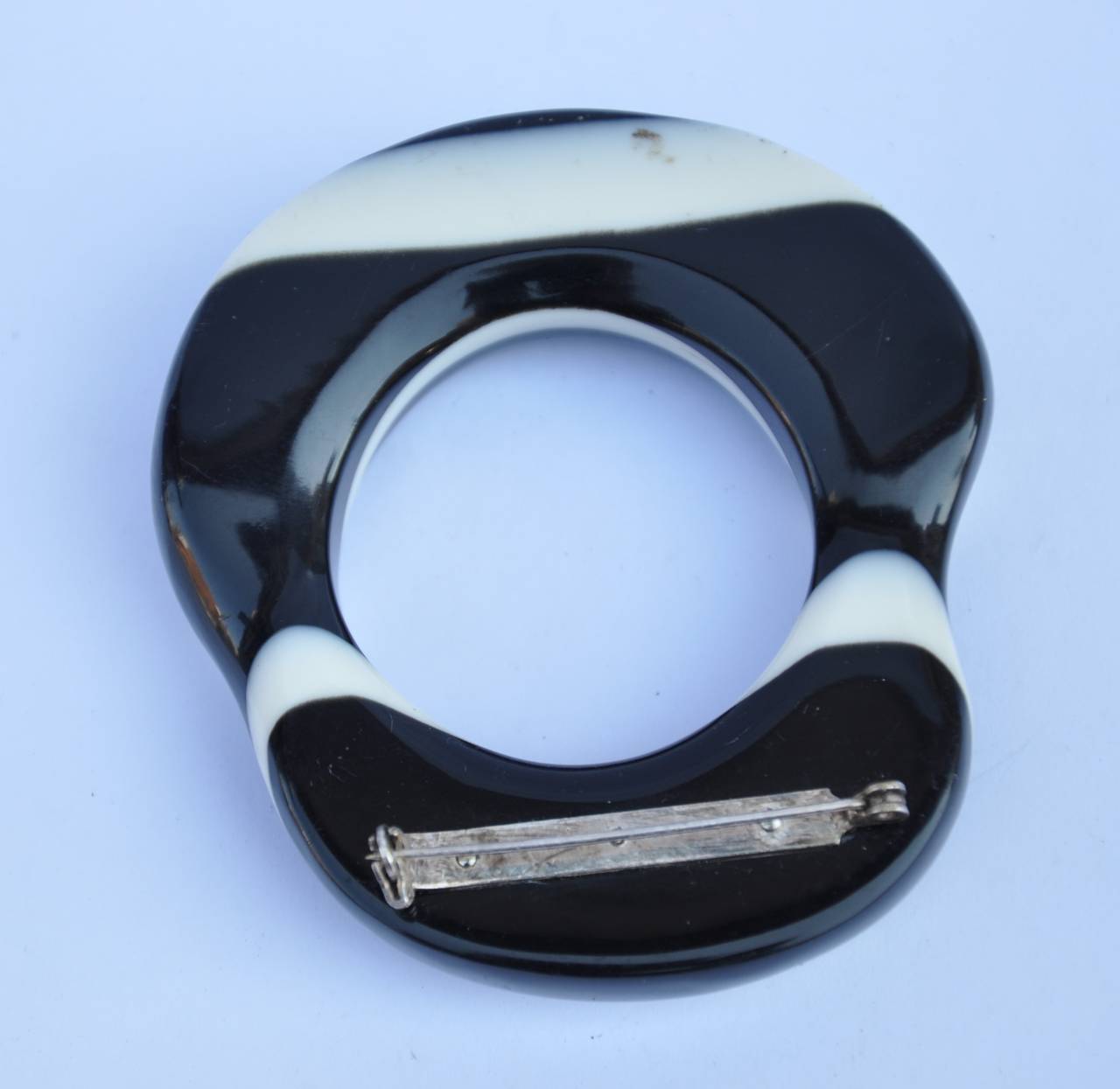 This huge black & white "Swirl" lucite brooch measures 3" x 2 5/8" with a thickness of 1/2".