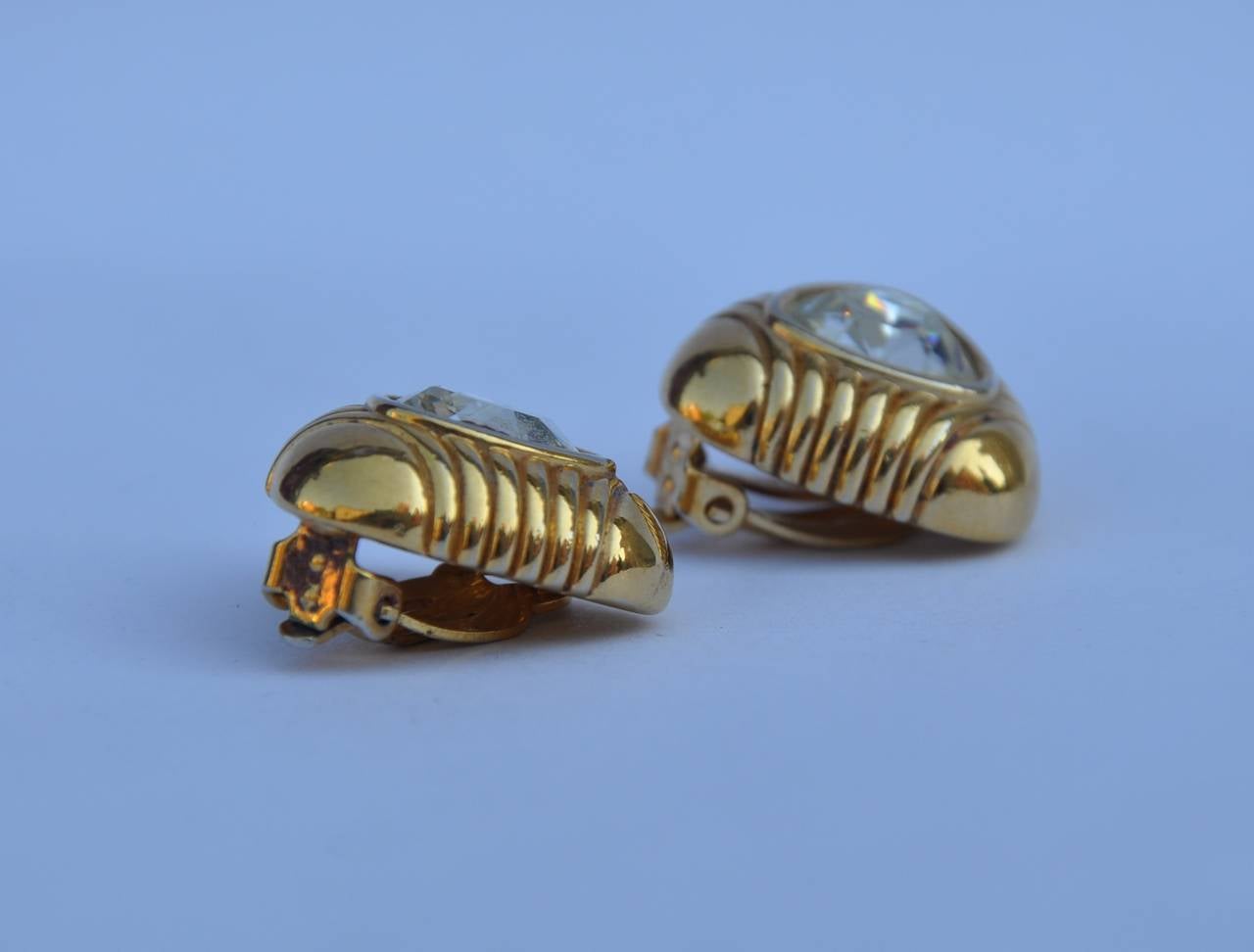 These large gilded gold accented with rhinestone ear clips measures 7/8" x 7/8" with a depth of 3/8".