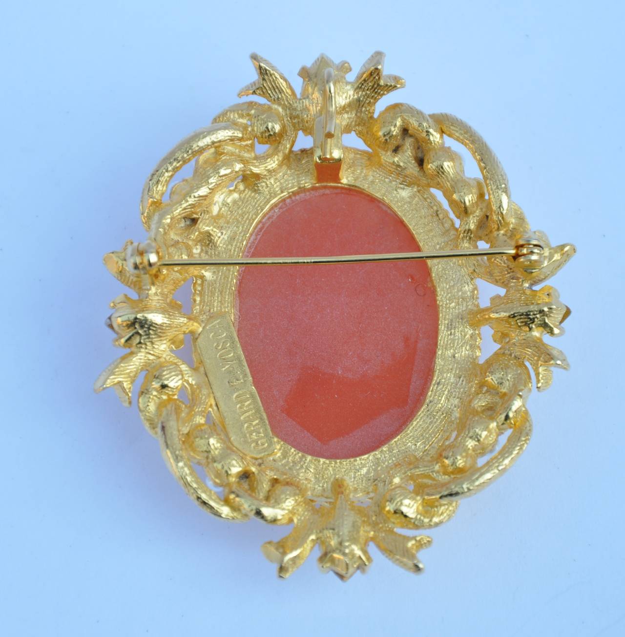 Gerard E. Yosca huge gilded gold vermeil finish cameo brooch is accented with seed pearls and rhinestones. The brooch measures 2 1/8" in length, 2 1/2" in height and 1/2" in depth.
