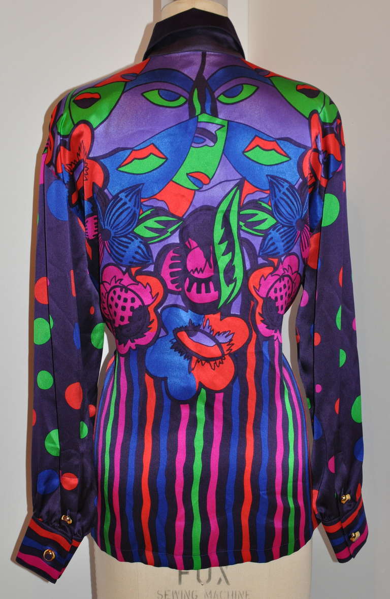 Escada by Margaretha Ley bold multi-color abstract silk crepe de chine blouse has seven (7) buttons hidden with a cover-flap of mother-of-pearls.
   The front length measures 24