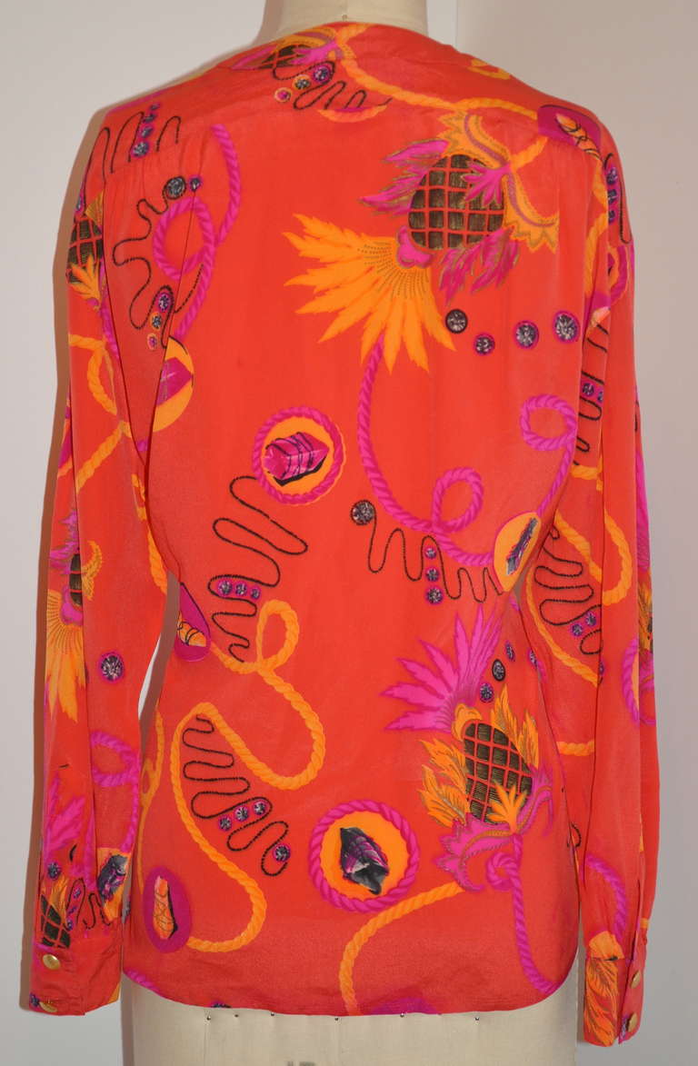 Escada by Margaretha Ley bold abstract tangerine with multi-color silk crepe de chine blouse is size 36/ West Germany.
   There are six (6) buttons on front with slightly drop shoulders.
   The front measures 23 1/2, back is 26 1/2