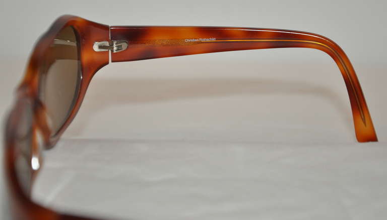 These elegant Christian Rothschild tortoise shell sunglasses are quietly accented with micro rhinestones on the sides.
   Height measures 1 5/8