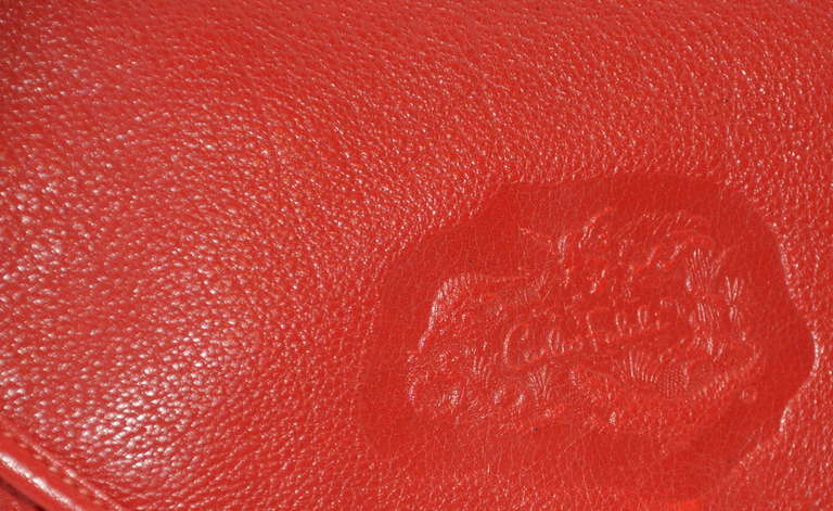 Carlos Falchi textured red calfskin drawstring clutch comes with a detachable strap of same textured red calfskin to be use for a shoulder bag if desired. The leather straps measures 50
