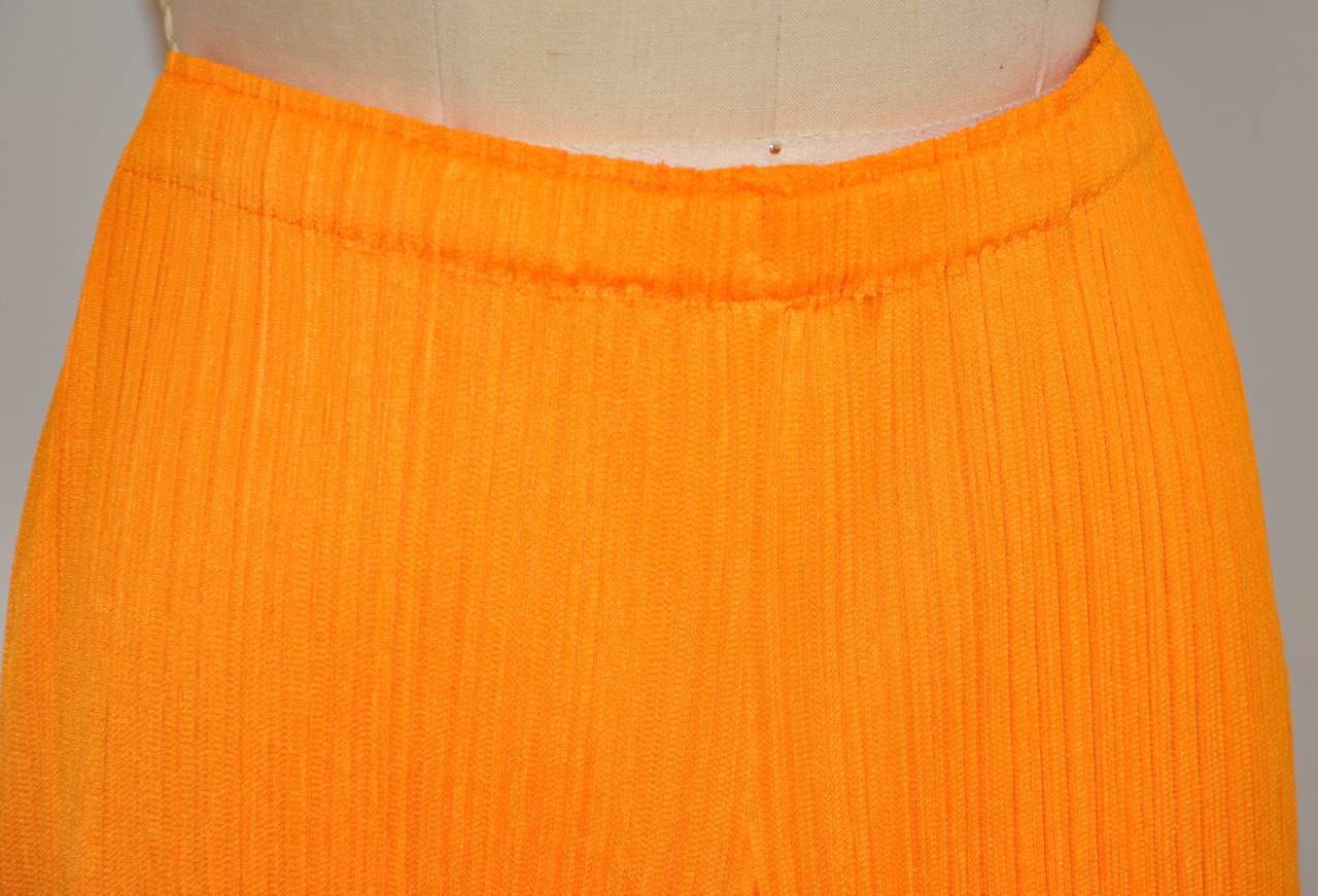 Issey Miyake signature pleated bold tangerine trousers are size 4/Japan. New and never worn, made in Japan. Total length measures 40