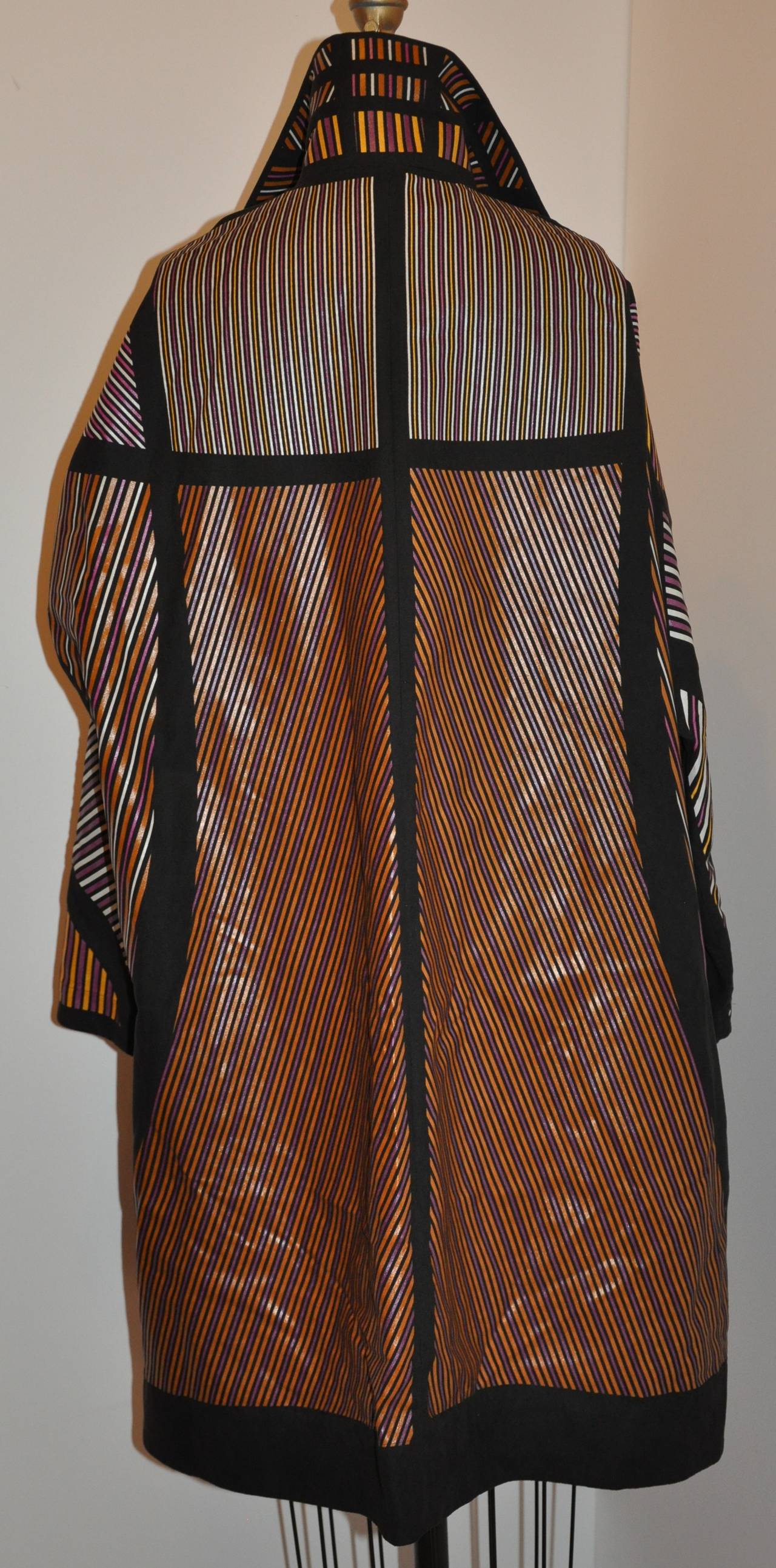 Issey Miyake multi-color multi-size stripe bold abstract car coat is size 2 taille/Japan. There are three (3) large lucite with hardware buttons in front with two(2) set-in pockets. The sleeves are slightly doman. The interior has detailed piping on