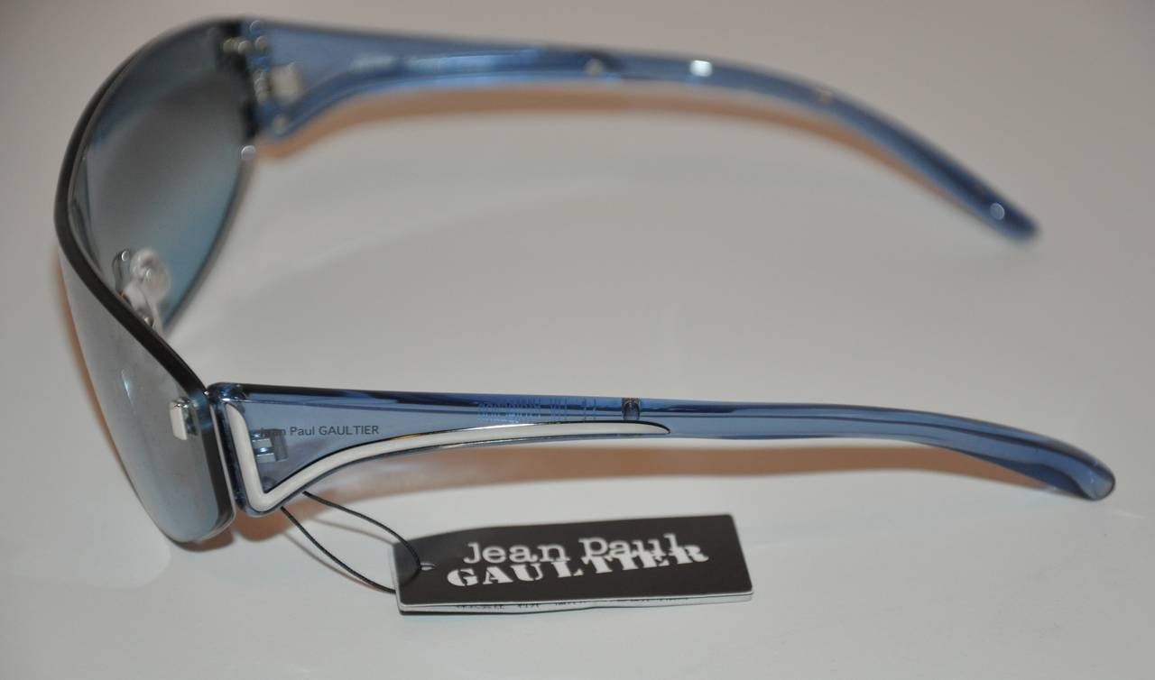 Jean Paul Gaultier blue lucite with blue shade sunglasses are accented with silver hardware. Never used and new, these sunglasses measures 5 5/8