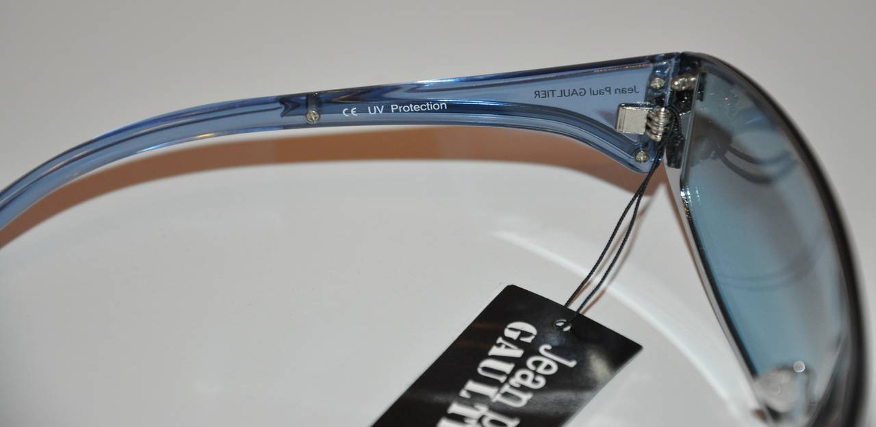 Jean Paul Gaultier blue lucite with blue shade sunglasses are detailed with silver hardware. The glasses measures 5 6/8