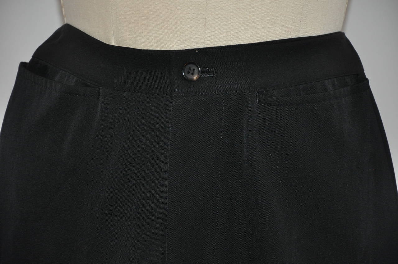          Yoshi Yamamoto black wool wide-leg trousers is size medium/Japan. The waist measures 28", waistband is 1 1/2" in width, hips are 40", inner leg length is 29 1/2", outer leg is 39 1/4", leg hem circumference is 20