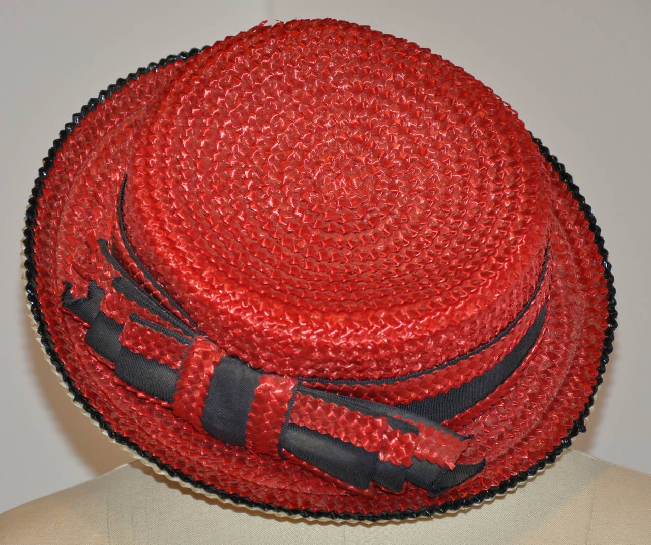 Yves Saint Laurent's combination of red, white and blue straw hat is accented with a large 9