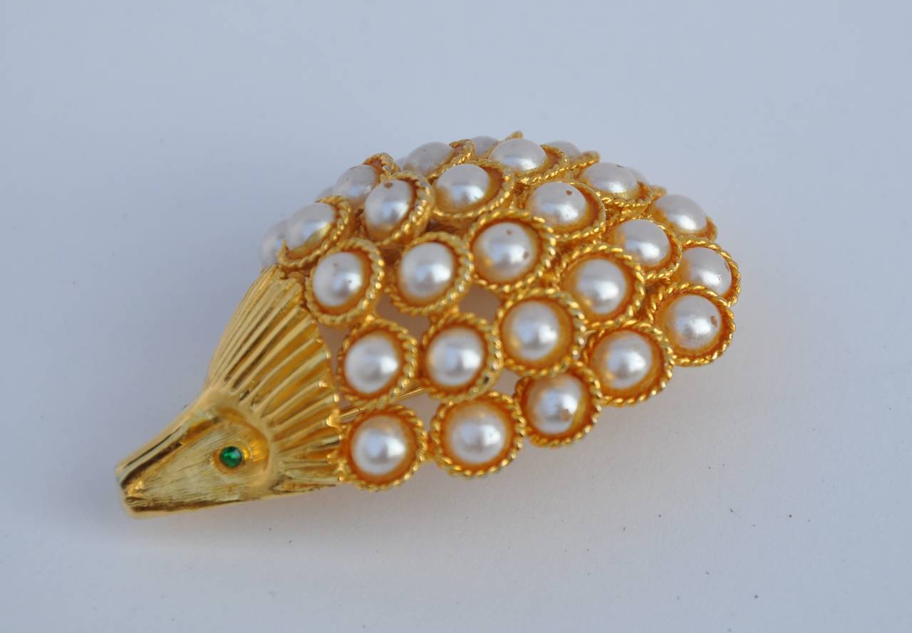 Capri's wonderful whimsical gilded gold vermeil accented with pearls and emerald rhinestone brooch measures 2" in length, 1 1/2" in width with a depth of 3/4". Brooch is signed on the backside.