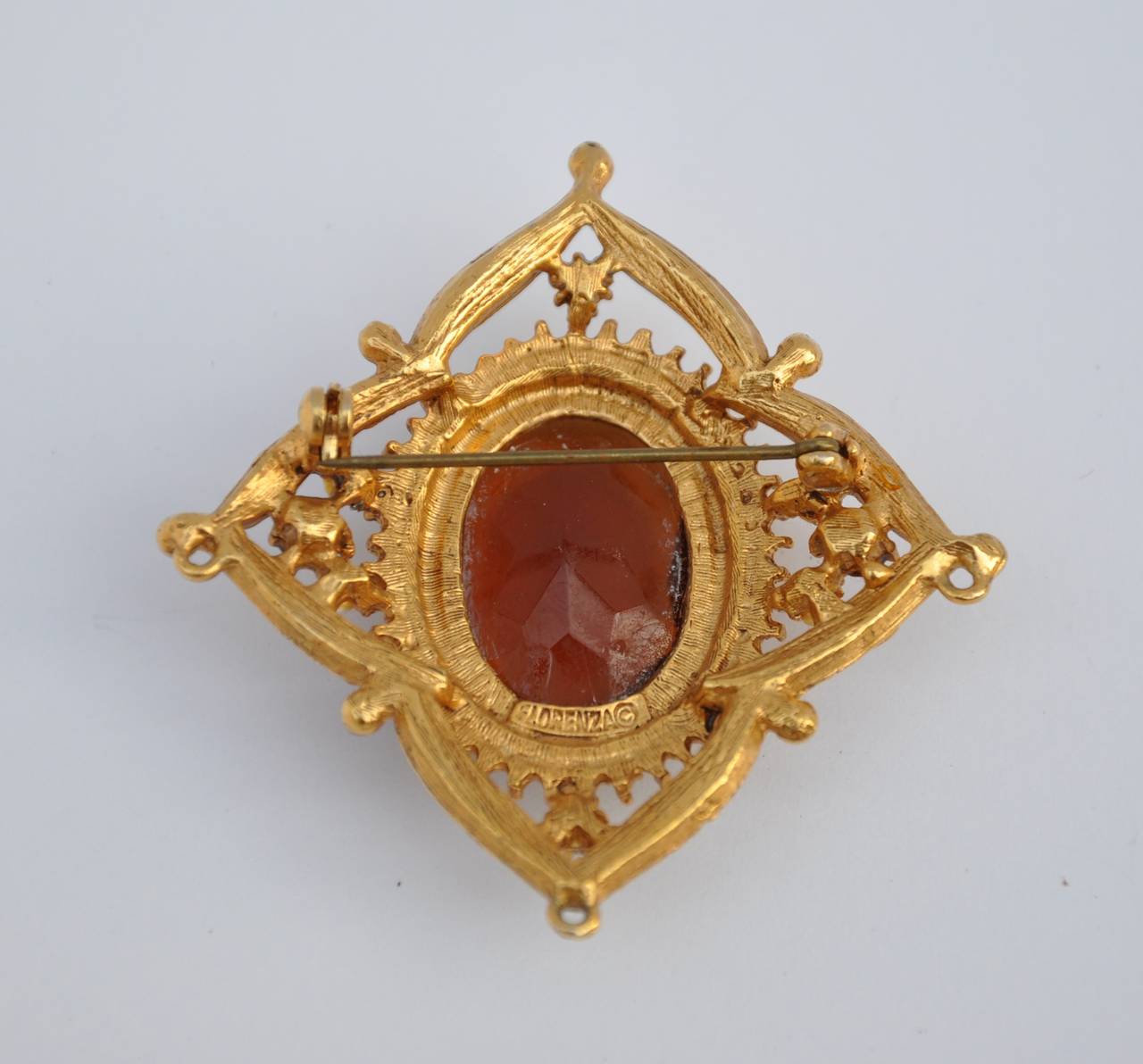 This wonderfully detailed gilded gold filigree vermeil finish brooch is detailed with multi-seed pearls and color resin stones. This wonderful brooch measures 2 1/8" in height, 2 1/8" in width and 1/2" in depth.